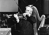 Medium chaplin playing violin and harp