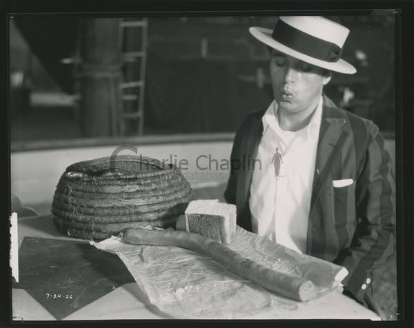 Chaplin contemplates a snake sandwich on the set of The Circus, circa 1926